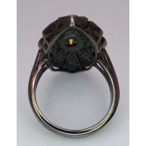 139 - An antique ARTS & CRAFTS sterling silver ring with a shield design adored with a central old cut dia... 