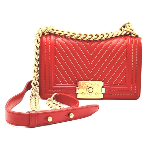 220 - A Chanel Red Boy Bag. Quilted leather exterior with gold-tone hardware, leather and chain strap and ... 