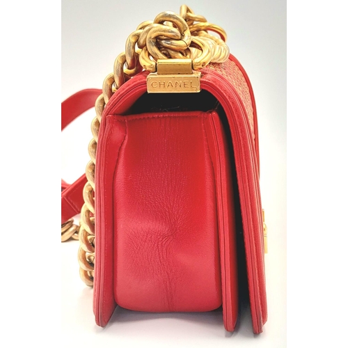 220 - A Chanel Red Boy Bag. Quilted leather exterior with gold-tone hardware, leather and chain strap and ... 