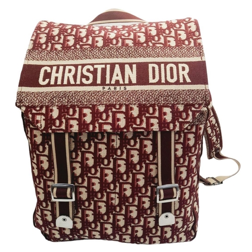 122 - A Christian Dior Burgundy Oblique Backpack. Monogram textile exterior with silver-toned hardware, ha... 