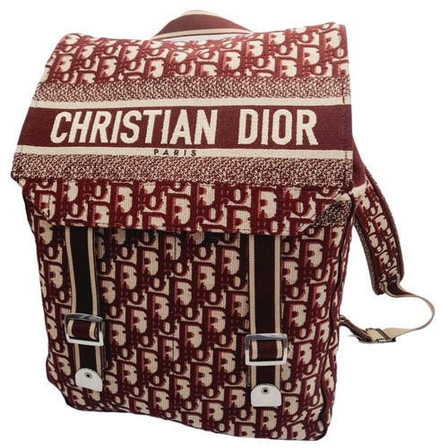 122 - A Christian Dior Burgundy Oblique Backpack. Monogram textile exterior with silver-toned hardware, ha... 