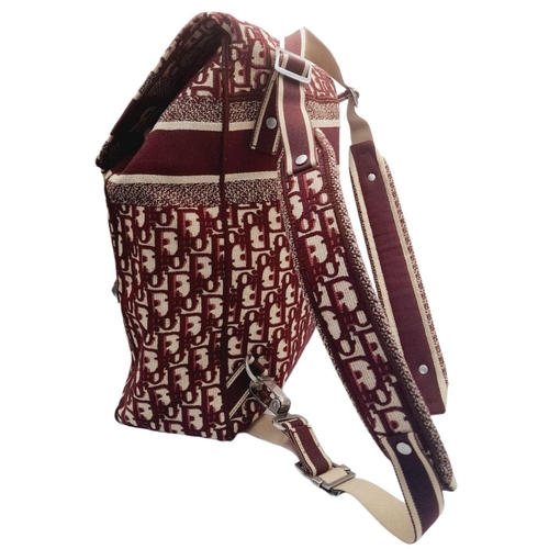 122 - A Christian Dior Burgundy Oblique Backpack. Monogram textile exterior with silver-toned hardware, ha... 