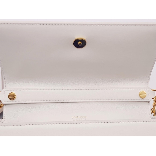 143 - A Tom Ford White Bianca Bag. Leather exterior with gold-toned hardware, handle and magnetic closure.... 