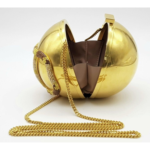 1173 - A Valentino Gold Orb Clutch Bag. Metal exterior with a stone embellished V logo and clasp fastening ... 