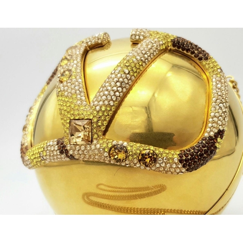 1173 - A Valentino Gold Orb Clutch Bag. Metal exterior with a stone embellished V logo and clasp fastening ... 