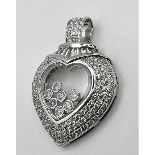 263 - A Beautiful 18K White Gold Diamond Encrusted Heart Pendant. Round and baguette cut diamonds with sev... 