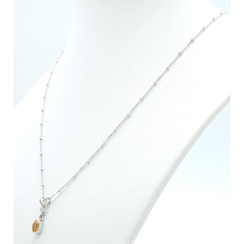 16 - An 18K White Gold Diamond and Citrine Necklace. 3.1g total weight. 0.03ct diamond weight. 40cm lengt... 