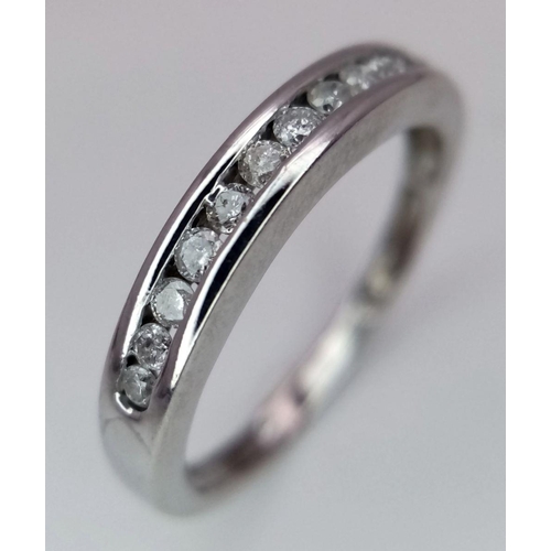 260 - A 9K White Gold (tested as) Half Eternity Ring. 1.6g total weight. 0.11ct diamond weight. Size I. Re... 