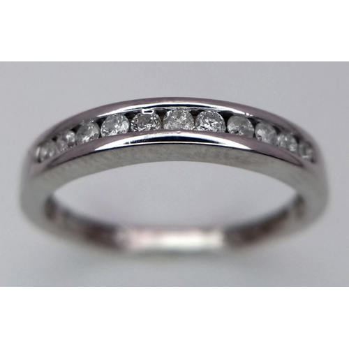 260 - A 9K White Gold (tested as) Half Eternity Ring. 1.6g total weight. 0.11ct diamond weight. Size I. Re... 