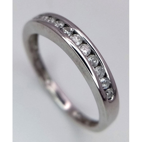 260 - A 9K White Gold (tested as) Half Eternity Ring. 1.6g total weight. 0.11ct diamond weight. Size I. Re... 