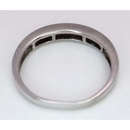 260 - A 9K White Gold (tested as) Half Eternity Ring. 1.6g total weight. 0.11ct diamond weight. Size I. Re... 