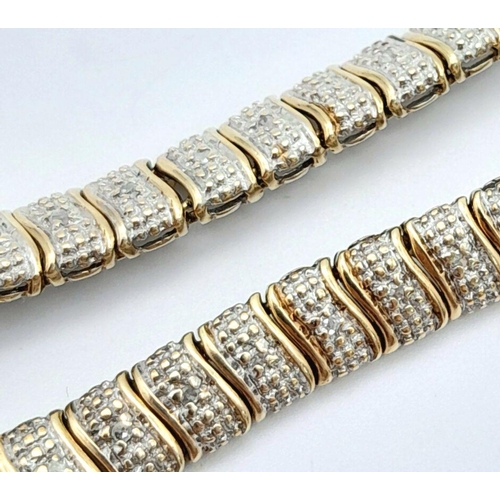 32 - A 9K Two-Tone Diamond Set Bracelet. 7.7g total weight. 0.26ct diamond weight. 20cm length. 7526H