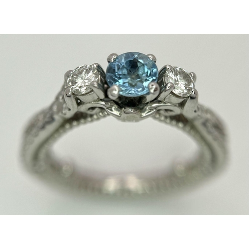 39 - An 18K White Gold Diamond and Topaz Ring. 5.9g total weight. 0.50ct diamond weight. Size G. 8573H