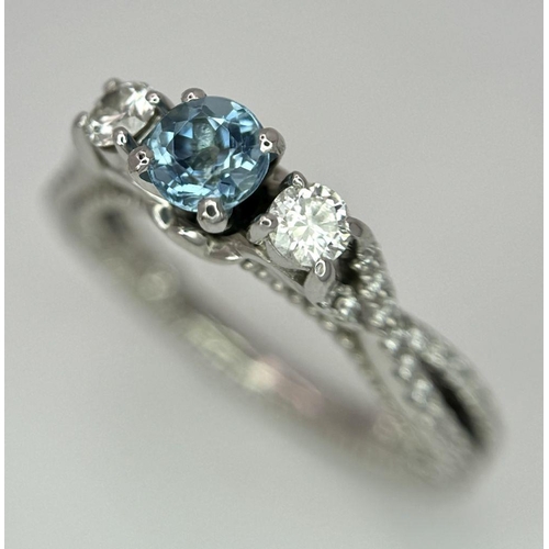 39 - An 18K White Gold Diamond and Topaz Ring. 5.9g total weight. 0.50ct diamond weight. Size G. 8573H