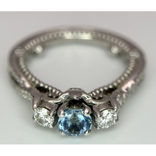 39 - An 18K White Gold Diamond and Topaz Ring. 5.9g total weight. 0.50ct diamond weight. Size G. 8573H