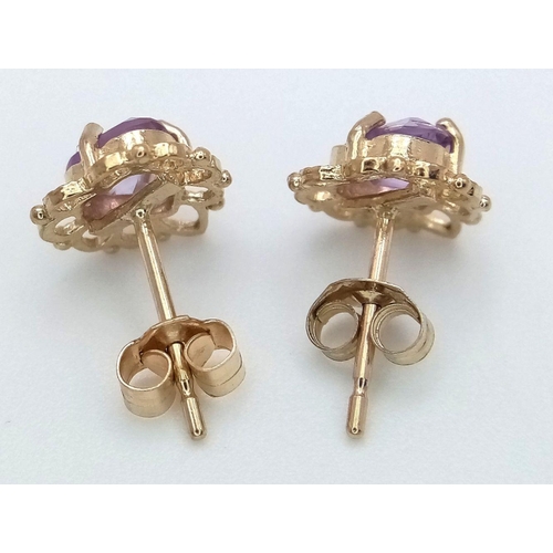 715 - A Pair of 9K Yellow Gold Amethyst Fancy Heart Stud Earrings. 1g total weight. JM19