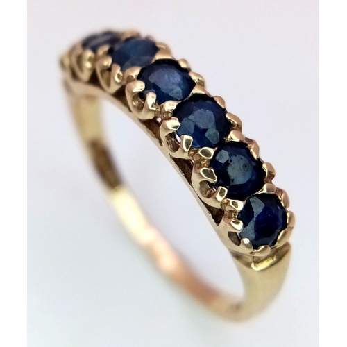 748 - A 9K YELLOW GOLD SAPPHIRE SET BAND RING. 2.2G IN WEIGHT. SIZE O. Ref: SC 5005.