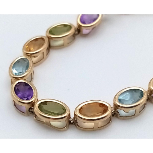 832 - A 9K YELLOW GOLD MULTI GEMSTONE SET BRACELET WITH SAFETY CHAIN. 6.45G IN WEIGHT. Ref: SC 5069.