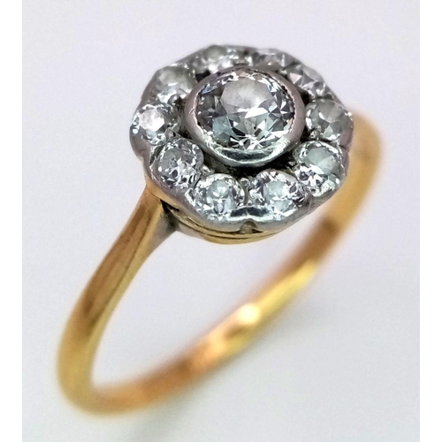 470 - An 18K Yellow Gold and Diamond Ring. Central diamond with a diamond halo. Size N. 2.3g total weight.