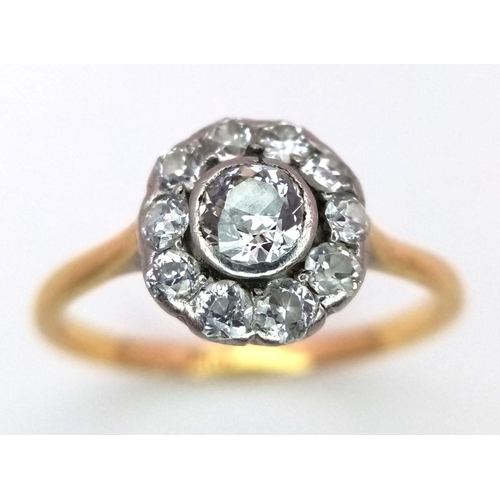 470 - An 18K Yellow Gold and Diamond Ring. Central diamond with a diamond halo. Size N. 2.3g total weight.