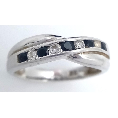 511 - Classic crossover style 9 carat WHITE GOLD RING set with SPINEL and ZIRCONIA. Full UK hallmark. 2 gr... 