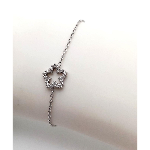 656 - A 18K WHITE GOLD DIAMOND SET STAR BRACELET 2.15G IN WEIGHT. 16CM IN LENGTH. Ref: SC 5047,