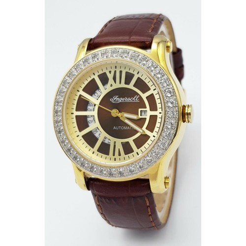 727 - An Ingersoll Automatic Stone Set Ladies Watch. Brown leather strap. Gilded stone set case - 34mm. Br... 