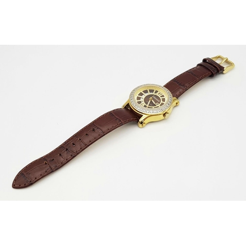 727 - An Ingersoll Automatic Stone Set Ladies Watch. Brown leather strap. Gilded stone set case - 34mm. Br... 