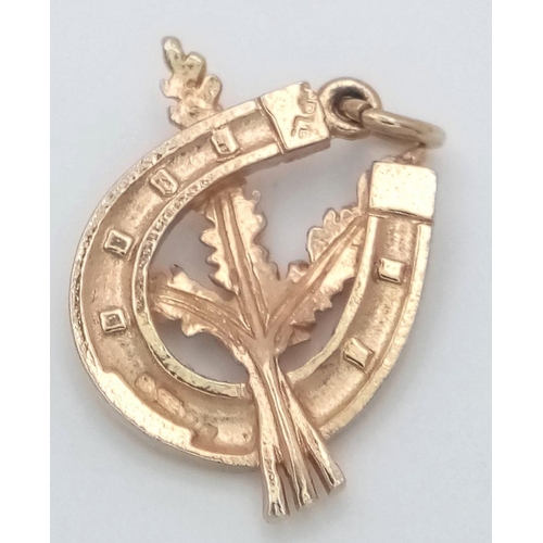 769 - A 9K YELLOW GOLD LUCKY HEATHER INSIDE A LUCKY HORSESHOE CHARM. 2.17G IN WEIGHT. 2.2CM IN LENGTH. Ref... 