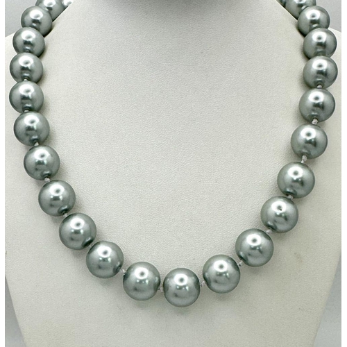 913 - A Metallic Silver South Sea Pearl Shell Bead Necklace. 14mm beads. 44cm necklace length.