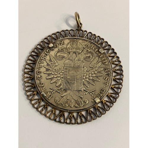 518 - Large SILVER THALER COIN 1780  in extra fine condition. Set in a filigree mount to be worn as a pend... 