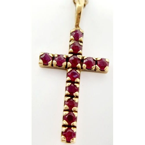 539 - Classic 9 carat GOLD CROSS set with RUBIES and mounted on a 9 carat fine GOLD CHAIN. Cross x 2.5 cm ... 