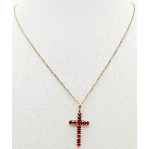 539 - Classic 9 carat GOLD CROSS set with RUBIES and mounted on a 9 carat fine GOLD CHAIN. Cross x 2.5 cm ... 