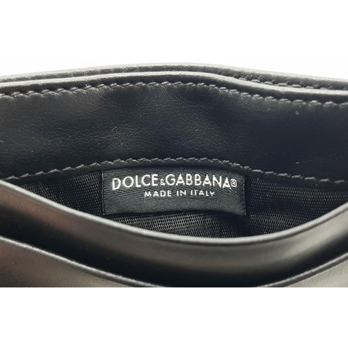 618 - A Dolce and Gabbana Small Leather and Textile Wallet. 9.5cm x 7cm.