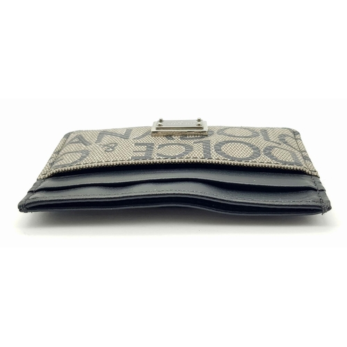 618 - A Dolce and Gabbana Small Leather and Textile Wallet. 9.5cm x 7cm.