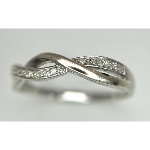 692 - A 9K WHITE GOLD DIAMOND SET TWIST CELTIC DESIGN RING. 1.9G. SIZE O. REF: SPAS 5006