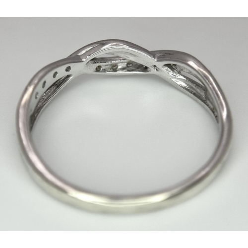 692 - A 9K WHITE GOLD DIAMOND SET TWIST CELTIC DESIGN RING. 1.9G. SIZE O. REF: SPAS 5006