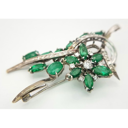 40 - An 18 K white gold brooch with a floral motif carrying oval and marquise cut emeralds  (5.5 carats a... 