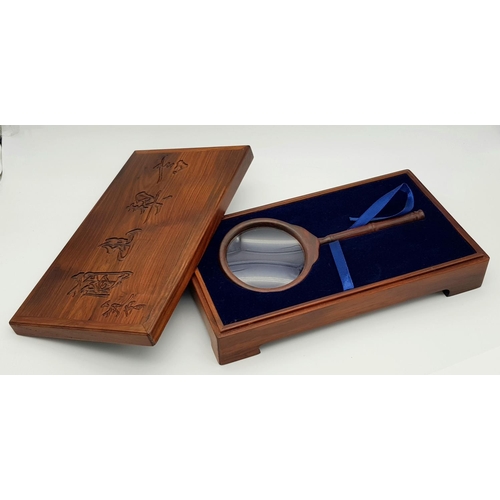 633 - A Wonderfully Constructed Chinese Wooden Magnifying Glass. Comes with a decorative fitted wooden cas... 