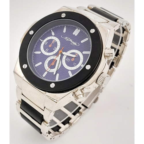 848 - An Ed Hardy Quartz Gents Watch. Stainless steel bracelet and case - 47mm. Still with tag. In case.