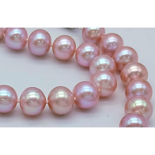 841 - A wonderful pearl necklace, with 10 mm round natural quality pearls exhibiting purple hues. Sterling... 