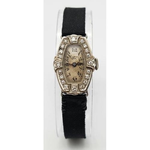 654 - A 1920s Art Deco Mappin and Webb Platinum and Diamond Cocktail Ladies Watch. Original textile strap.... 