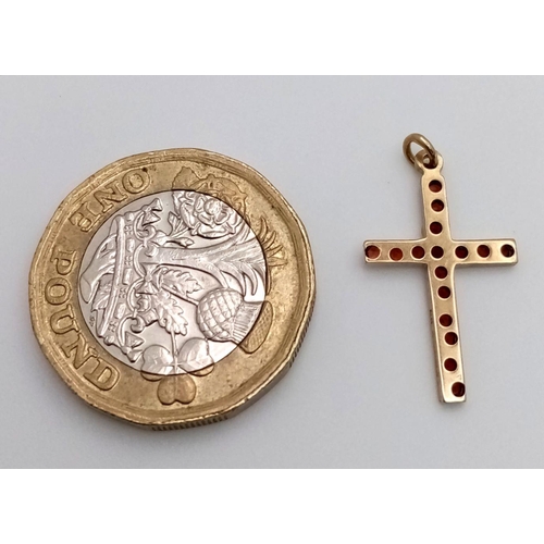 1120 - A 9K YELLOW GOLD RED STONE SET CROSS. 0.55G IN WEIGHT. Ref: SC 5067.