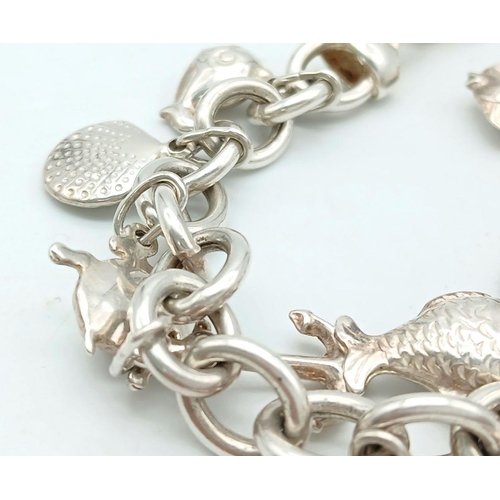 1133 - A Heavy Sterling Silver Charm Bracelet with Twelve Silver Sea Related Charms, many scarce. 20cm Leng... 