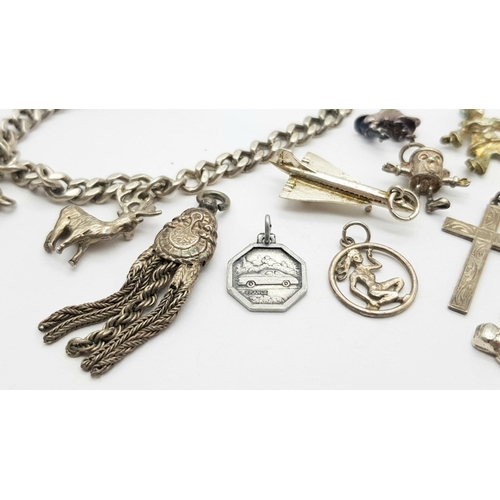 892 - A sterling silver chain bracelet and a total of fifteen charms including a post box, a teddy bear, a... 