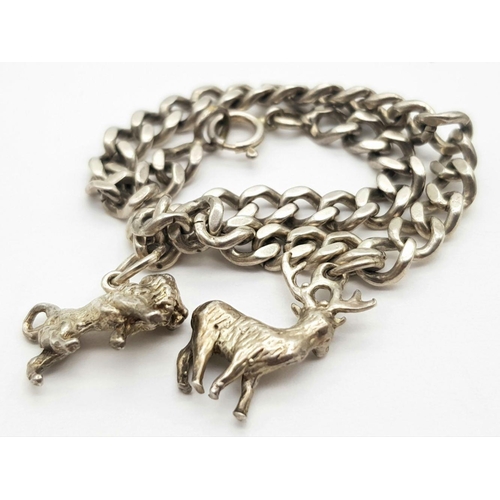 892 - A sterling silver chain bracelet and a total of fifteen charms including a post box, a teddy bear, a... 