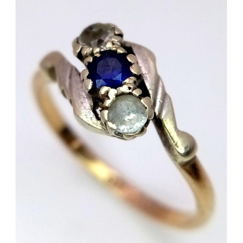 906 - A vintage 9 K yellow gold ring with a round cut blue sapphire  accompanied by two round cut diamonds... 