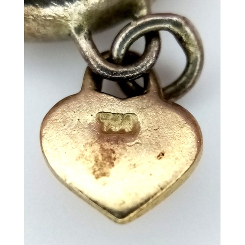 926 - A Vintage Silver Ring With a Hanging Gold (tests as 9k) Charm. Size H.