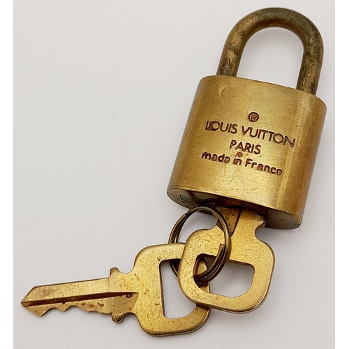 1055 - A Louis Vuitton Small Travel Padlock and Two Keys. 3.5cm.