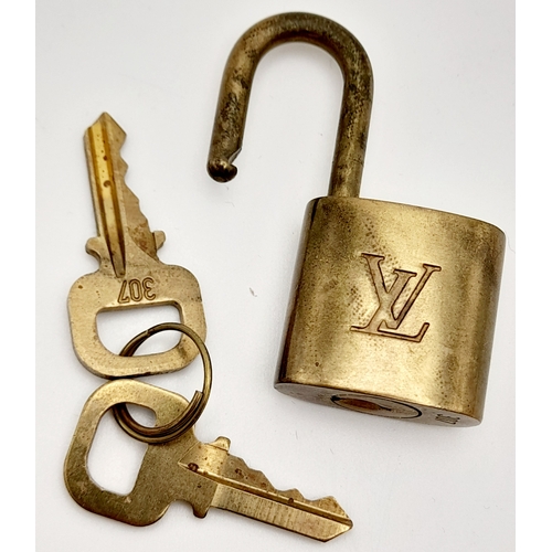 1055 - A Louis Vuitton Small Travel Padlock and Two Keys. 3.5cm.